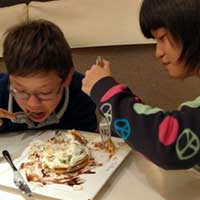 The kids inhaling their dessert.