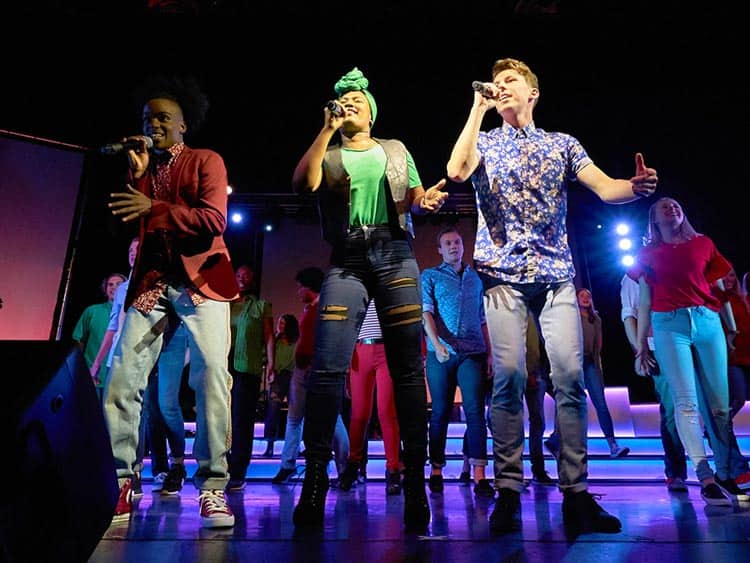 up with people cast members performing a musical show internationally