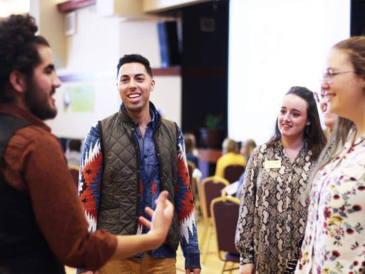 up with people cast discussing issues in workshop