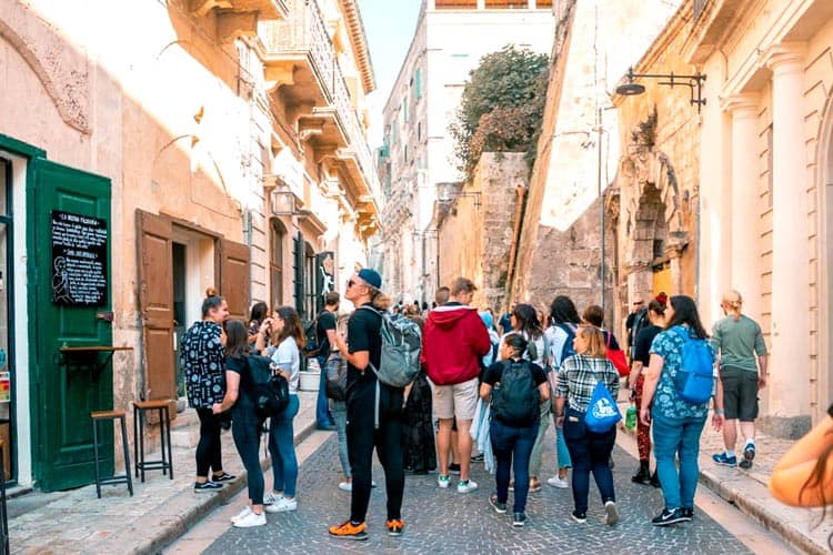 up with people cast doing a walking tour in italy
