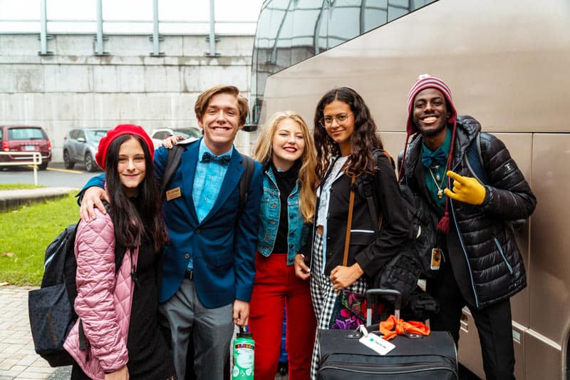up with people cast standing by a bus