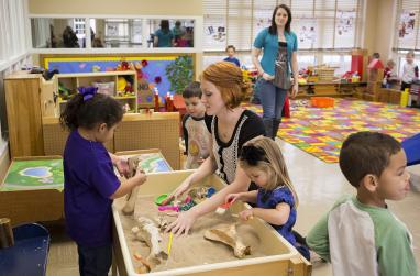 Picture of a USAO student working with children in the Child Development Center.