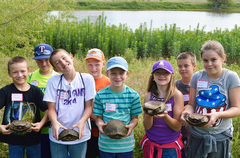 Brain Waves campers show off turtles collected at the USAO Habitat.