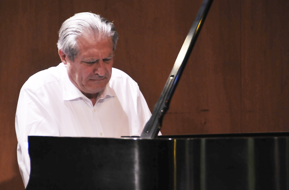 A photo of Dr. Dex Marble playing the piano.