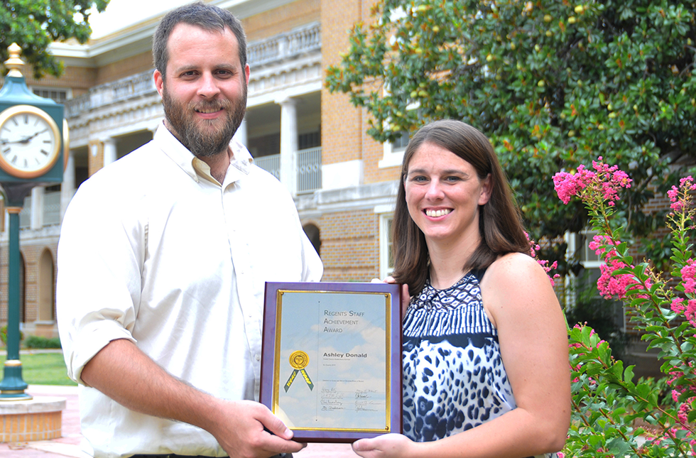 Ashley Donald, administrative assistant for USAO Student Services, receives her Staff Achievement Award from Adam Heilman, the 2012-13 Employee of the Year.