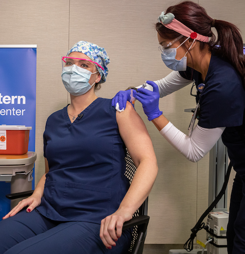 woman receiving a COVID-19 vaccination shot