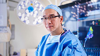 Surgeon in scrubs standing in an advanced operating room
