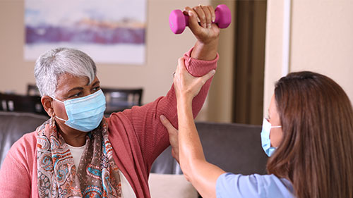 Nurse helping patient during rehabilitation