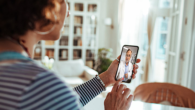 Female patient on her phone during a doctor video visit