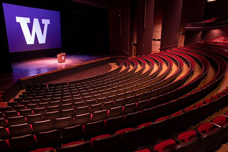 Meany auditorium with W logo on screen behind the stage
