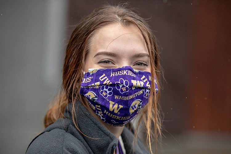 Person wearing UW-branded face mask