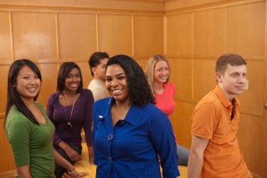 Students in paneled room.