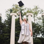 Hannah tossing her graduation cap in the air at Sylvan Grove