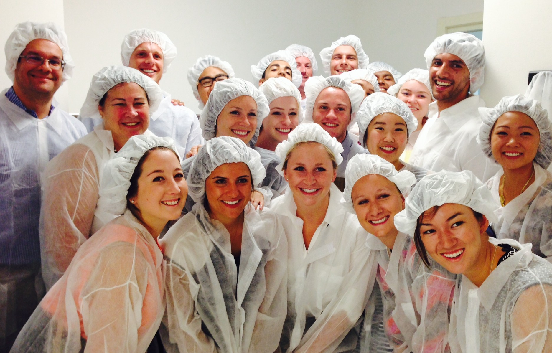 Students and professor at a factory