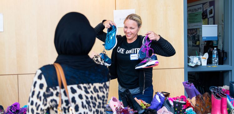 A person holds shoes at a Family Resource Exchange event