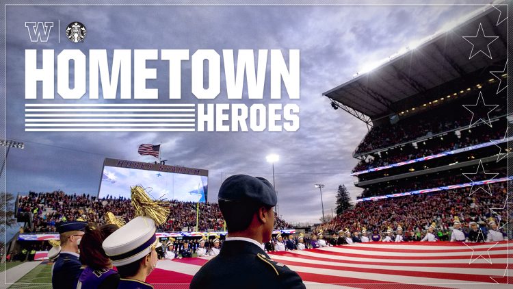 Military members stand during a flag presentation at Husky Stadium