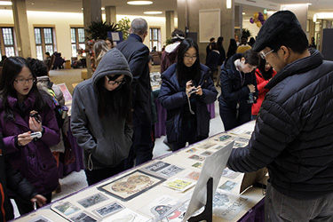 people looking at artifacts laid out on a table