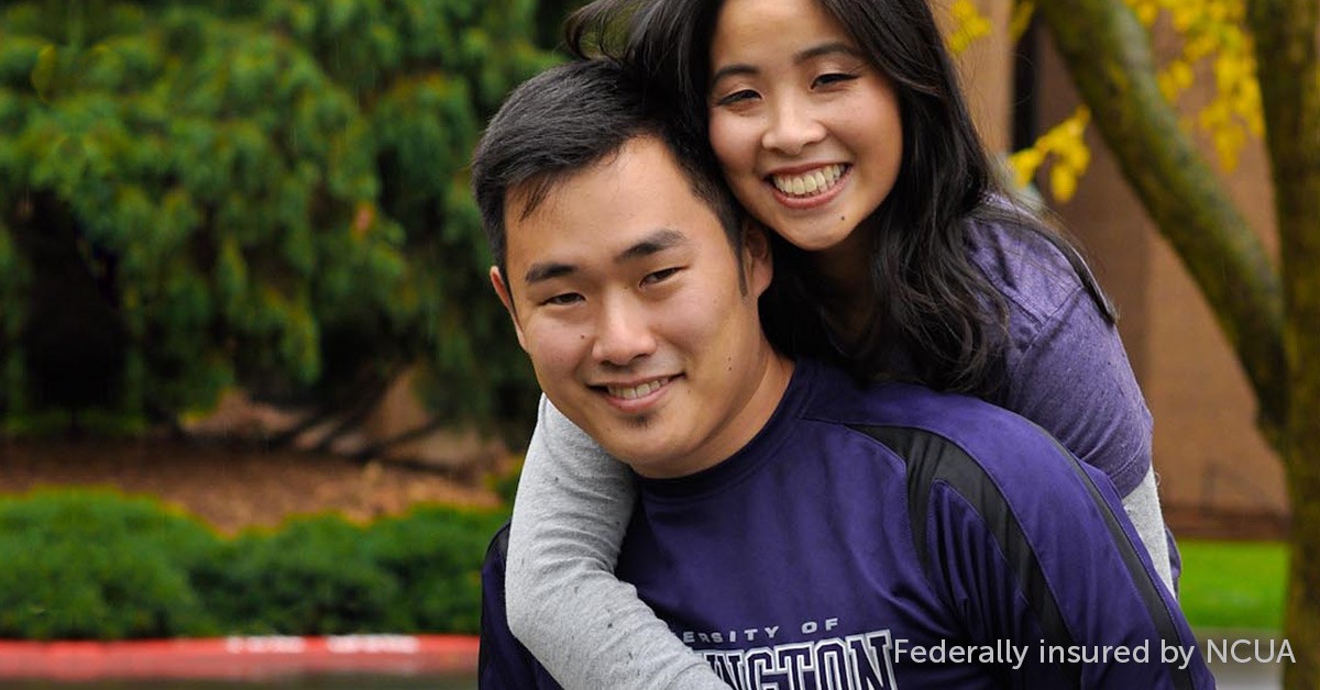 A man and a woman pose for a photo in a nature setting.