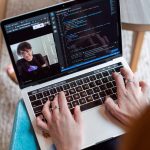 Person working on laptop and video conferencing