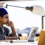 Student working on laptop.