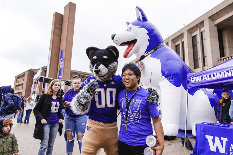 Harry Husky poses with student on Red Square.