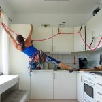 UW alumna Nicole Savage rock climbs her kitchen cabinets.