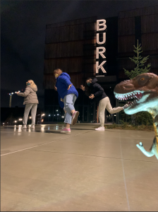 Participants feign running from a dinosaur at the Burke Museum.