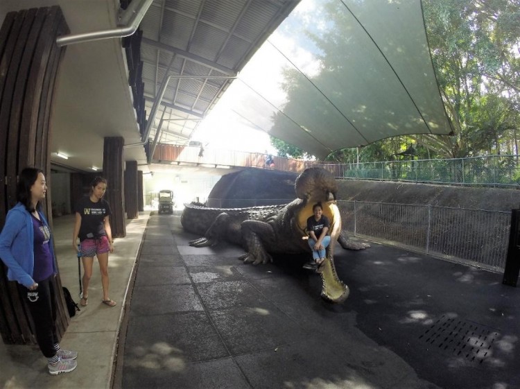 Yuliana taking a picture inside the giant crocodile as Tiffany, Jingyang and I stand by to take a group picture.