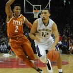 Andrew Andrews drives around Texas defender
