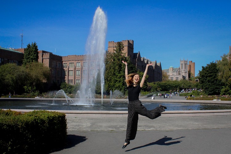 Melissa Krook jumping in front of fountain