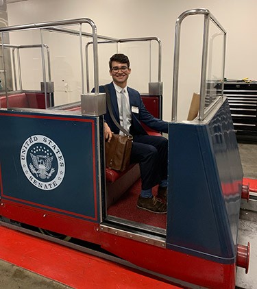 Hugo sits in the trolley.