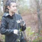 Photo of student working to remove invasive ivy