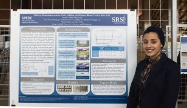 Photo of Maha Alhomoud in front of her research poster
