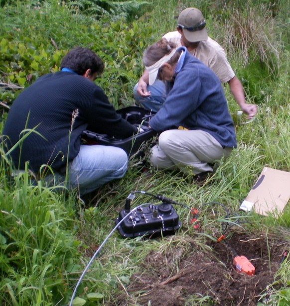 image_medium A seismic sensor (orange device) and datalogger (black box) are installed as part of one station in the “array of arrays” on the Olympic Peninsula in Washington state. The researchers are, from left, Danilo Galluzzo of Italy’s Istituto Nazionale di Geofisica e Vulcanologia, Noel Barstow of the Iris/Passcal Instrument Center and Abhijit Ghosh of the UW. (Credit: Lisa Foley, Iris/Pascal Instrument Center)