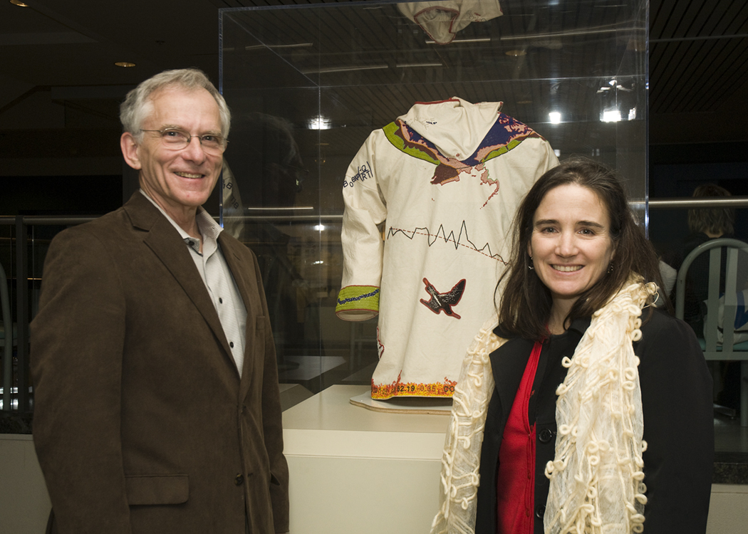 Robert Houze and Cecilia Bitz of atmospheric sciences, with 'The Melt,' created by Scott Schuldt and Bitz, beadwork on a canvas anorak that represents Bitz's research in the Arctic. Not shown is their colleague, Miles Logsdon. | Photo by Mary Levin.