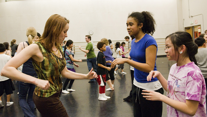 UW Dance Professor Juliet McMains gets down with Amazing Grace students Chinwe Ezeonu and Tiffany Dinh. | Photo by Kathy Sauber.