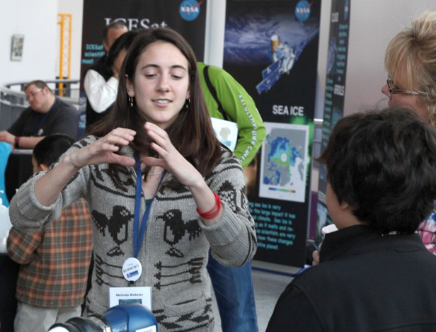 Oceanography graduate student Melinda Webster explains buoys that measure air temperature, air pressure and sea ice drift. Credit required: Dan Clark/UW Applied Physics Laboratory