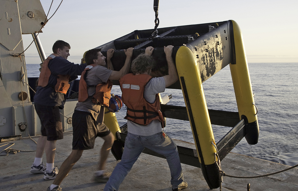 Crew members work with the Triaxus that conducts rapid 3-D surveys of ocean fronts while towed behind a ship. It was developed by manufacturer MacArtney and a UW team led by Craig Lee and Jason Gobat.