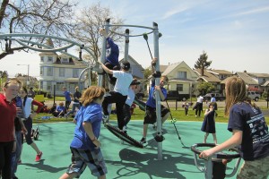 Kids pile on the new playground equipment Kids pile on the new playground equipment