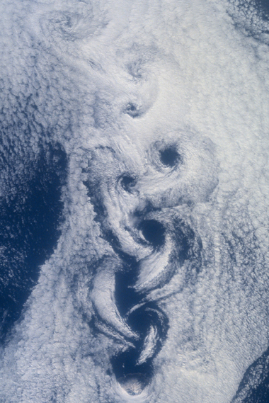 A 2001 photo from the space shuttle shows a phenomenon called von Karman vortices in clouds downwind from Rashiri Island in the northern Sea of Japan. The vortices are similar to those that form in superfluids.