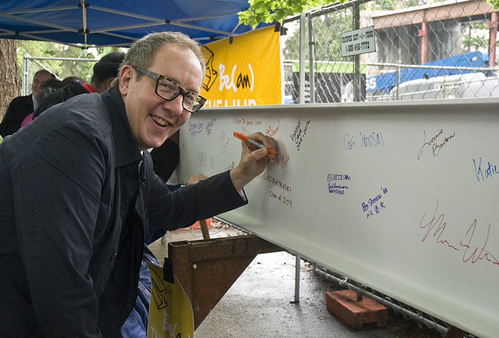 Associate Vice President for Campus Life Lincoln Johnson signs a beam that will be part of the refurbished HUB.