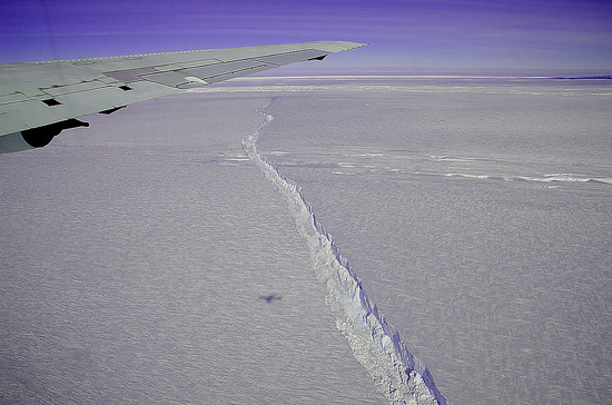A photo from the window of a NASA aircraft shows the rift across the Pine Island Glacier ice shelf running off toward the horizon. The plane flew across the crevasse on Oct. 26, 2011 as part of Operation IceBridge, taking detailed measurements of depth, width and shape. The ice shelf has not calved a major iceberg since 2001.