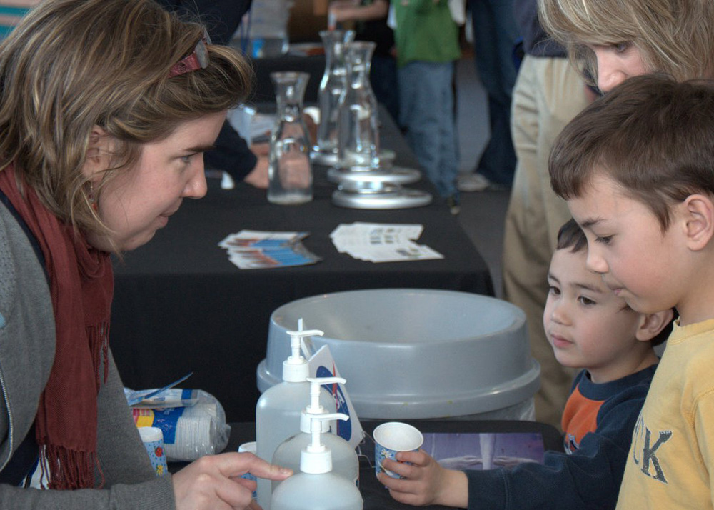 Camille Lique, a UW post-doctoral fellow, offers tastes of salty water as a way to understand the difference in the saltiness of Arctic Ocean water and Atlantic Ocean water.