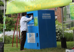 Student donates clothing at a collection site outside Terry Hall