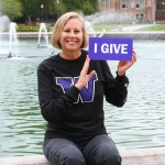 A campaign contributor holds a sign saying I give.