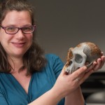 Rebecca Price holds the skull of a chimpanzee.