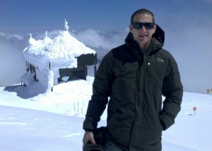 David Smith stand in front of the snow encrusted building housing the Mt. Bachelor oberservatory