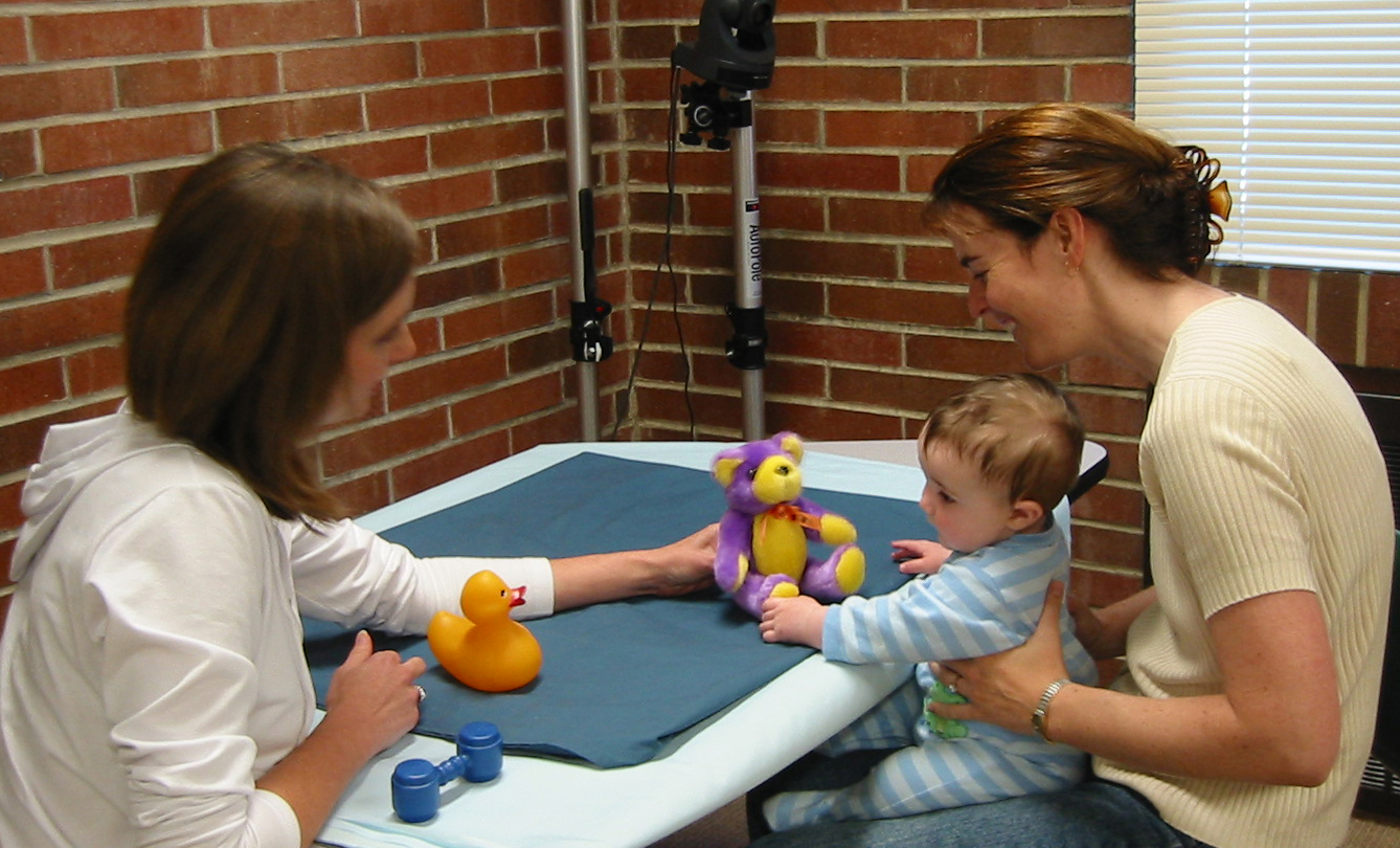 One year old baby with experimenters