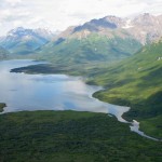 Mountains surround lake, stream in Alaska