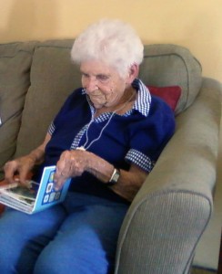 A healthy woman, about to turn 94, enjoys a family album. UW researchers are working to reduce the effects of aging and diseases of old age.